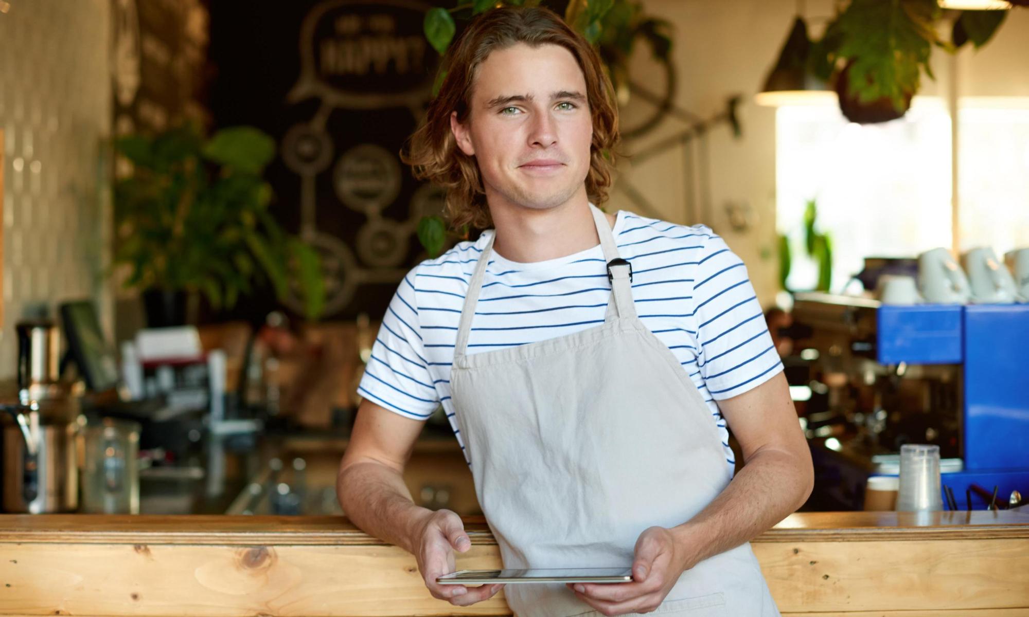 Young man working in a coffee shop